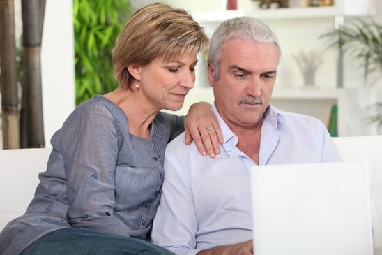 Middle-aged couple with a computer