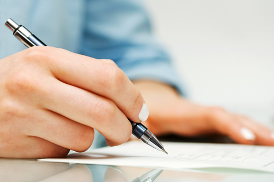 Businesswoman signing the contract.